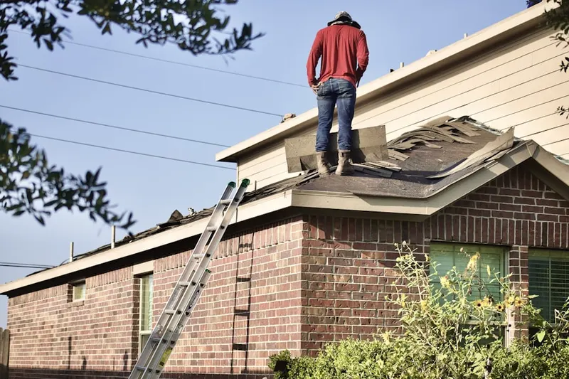 Professional roofer working on a residential roof in Biloxi